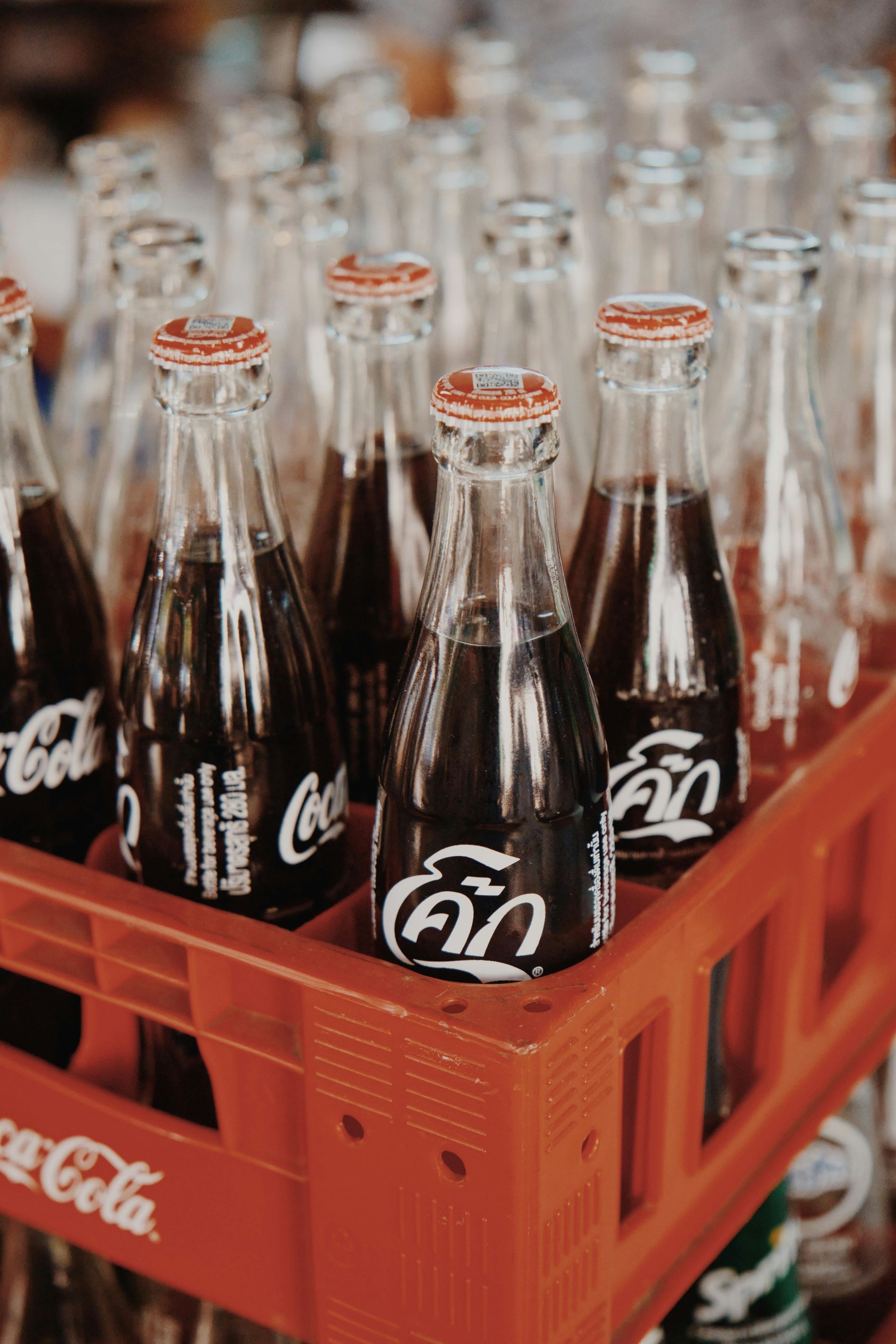 A crate filled with lots of coca cola bottles.