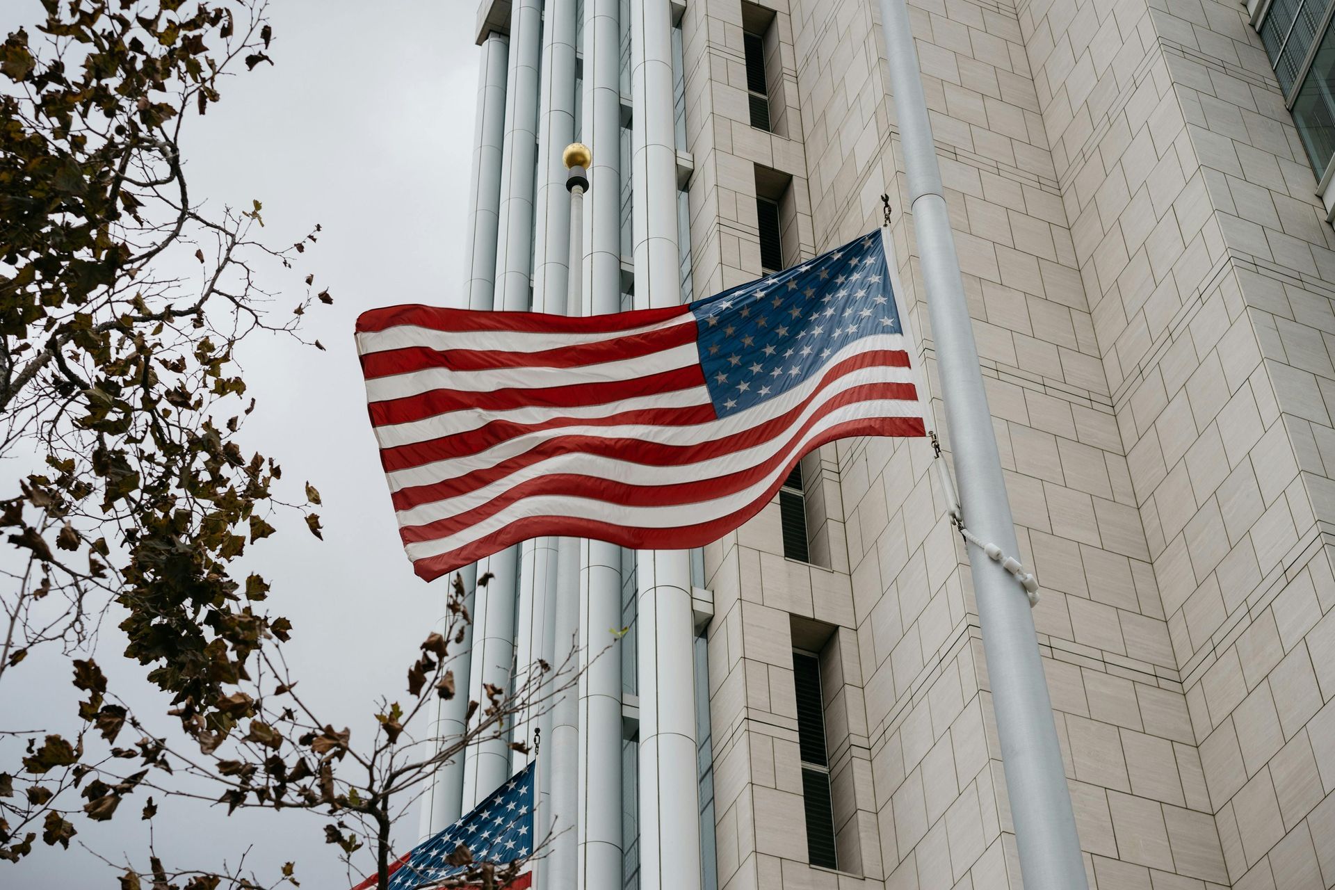 An american flag is flying in front of a building