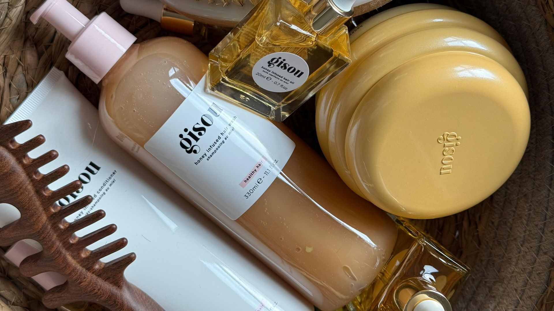 A basket filled with bottles of cosmetics and a comb.