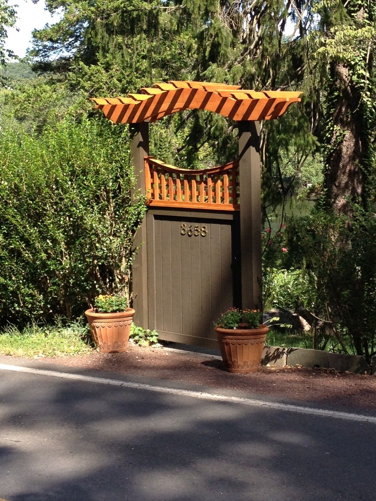 A wooden gate with the number 5486 on it