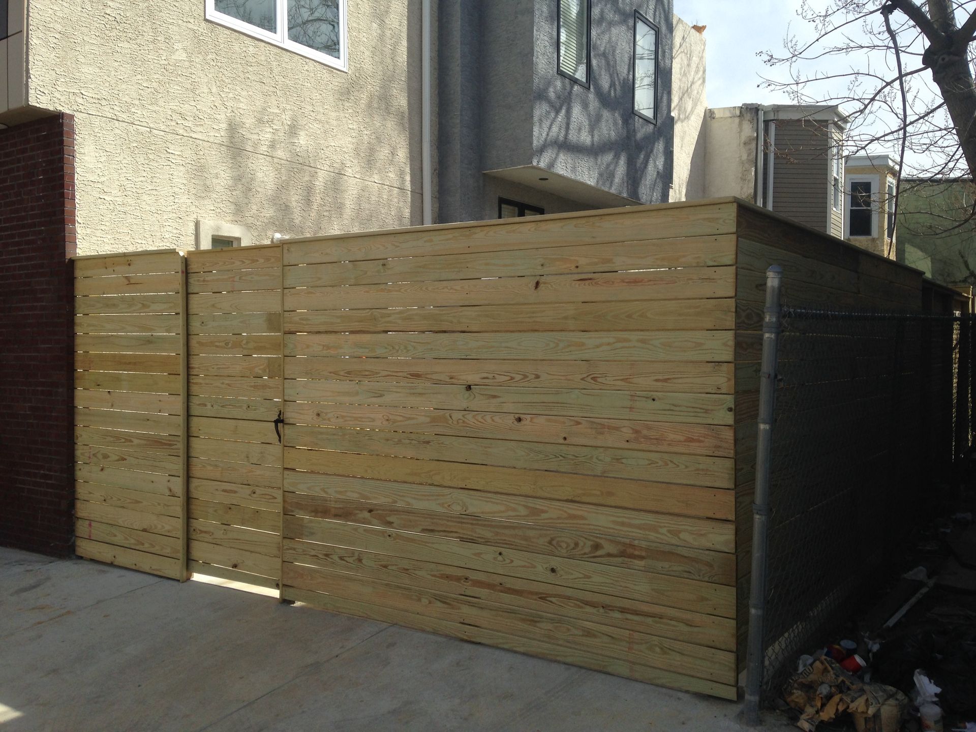 A wooden fence is in front of a building