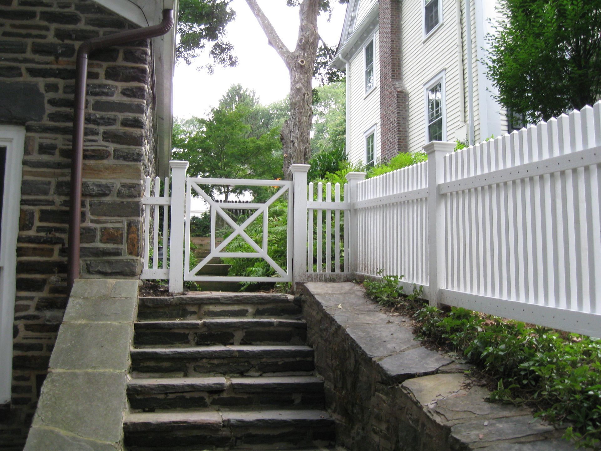 A white picket fence surrounds a set of stairs