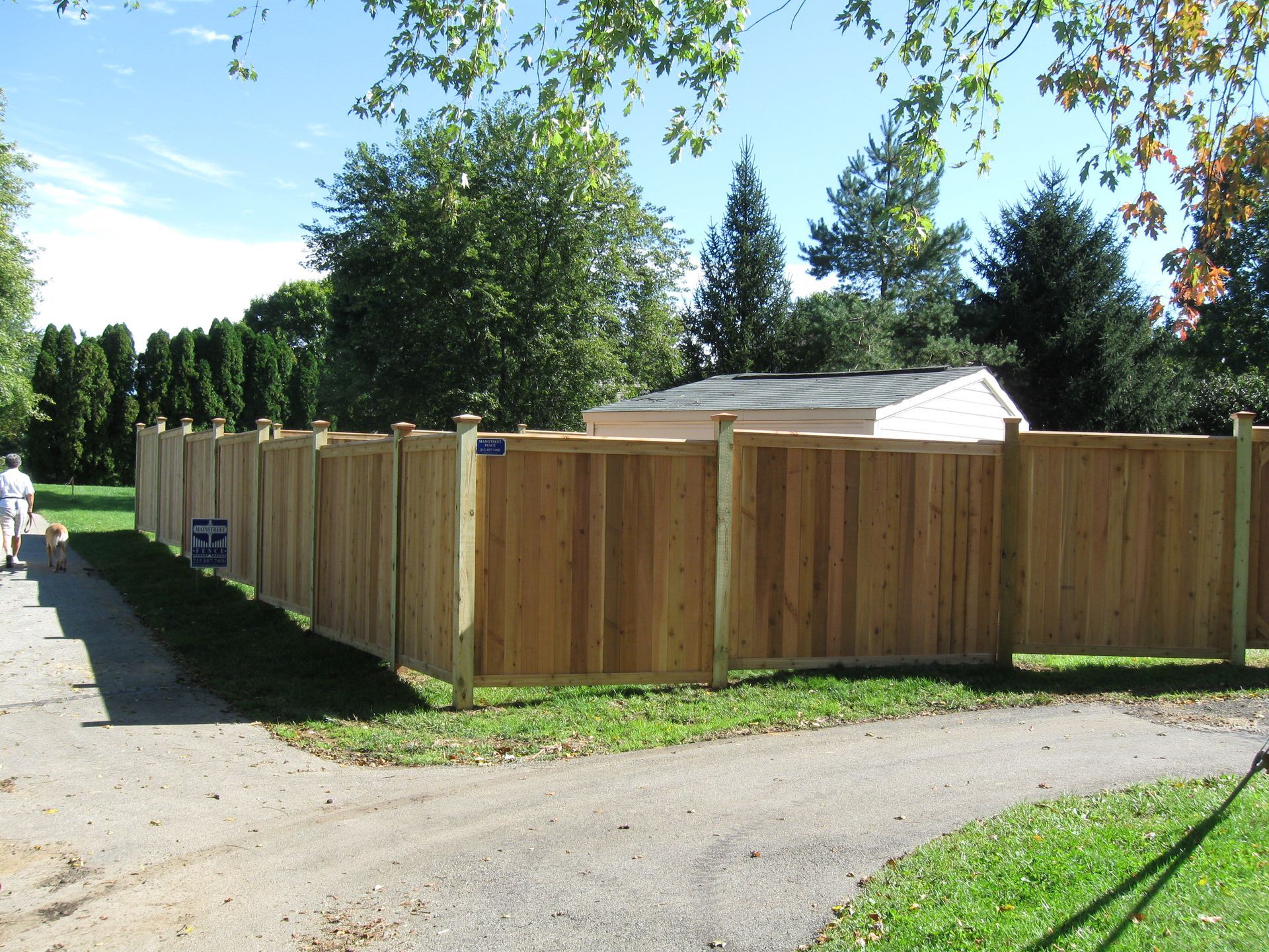 A wooden fence along the side of a road