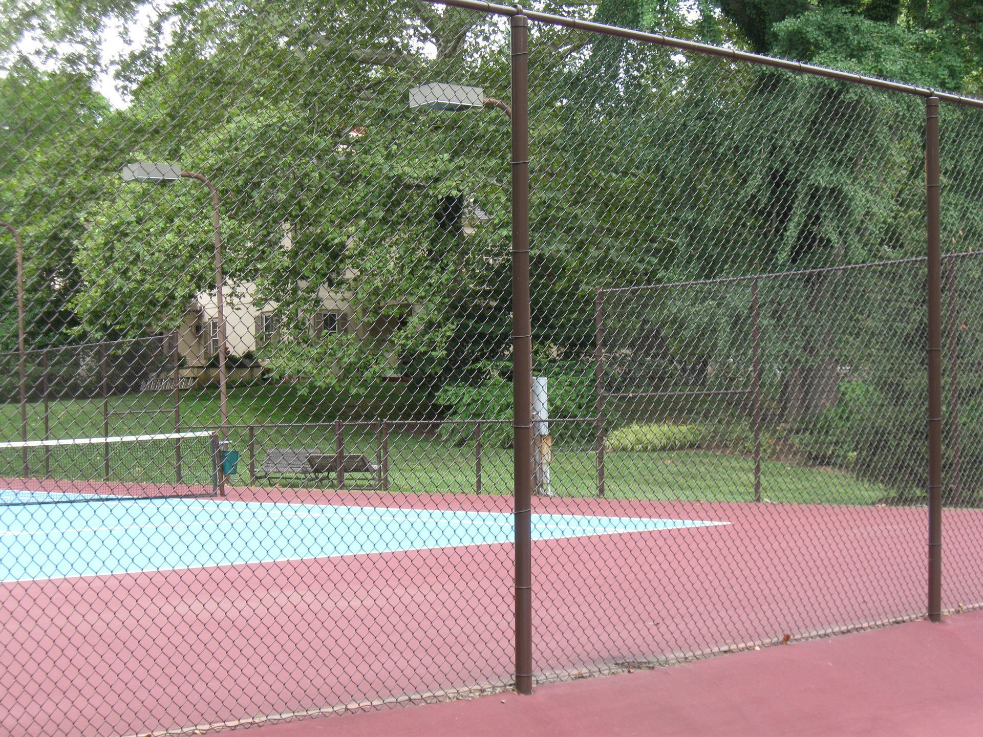 A tennis court with a chain link fence around it