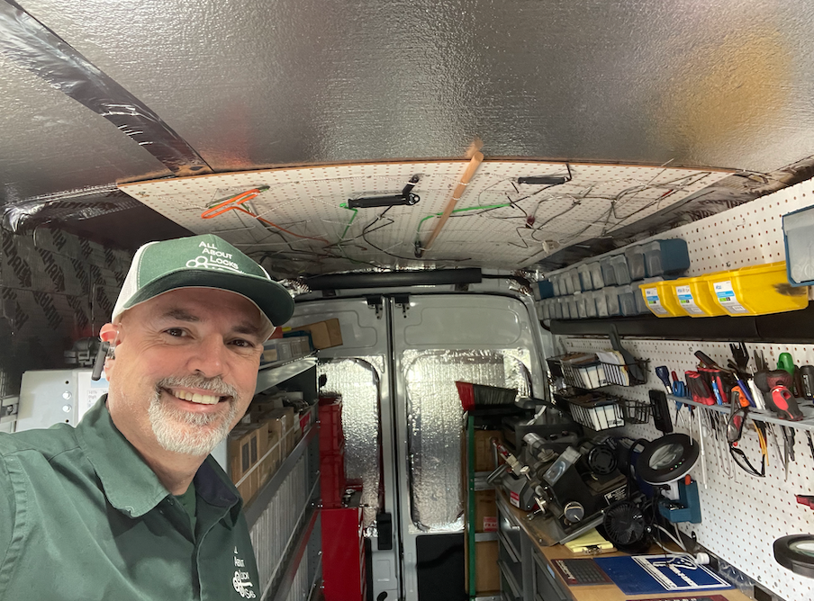 A man is standing in the back of a van.