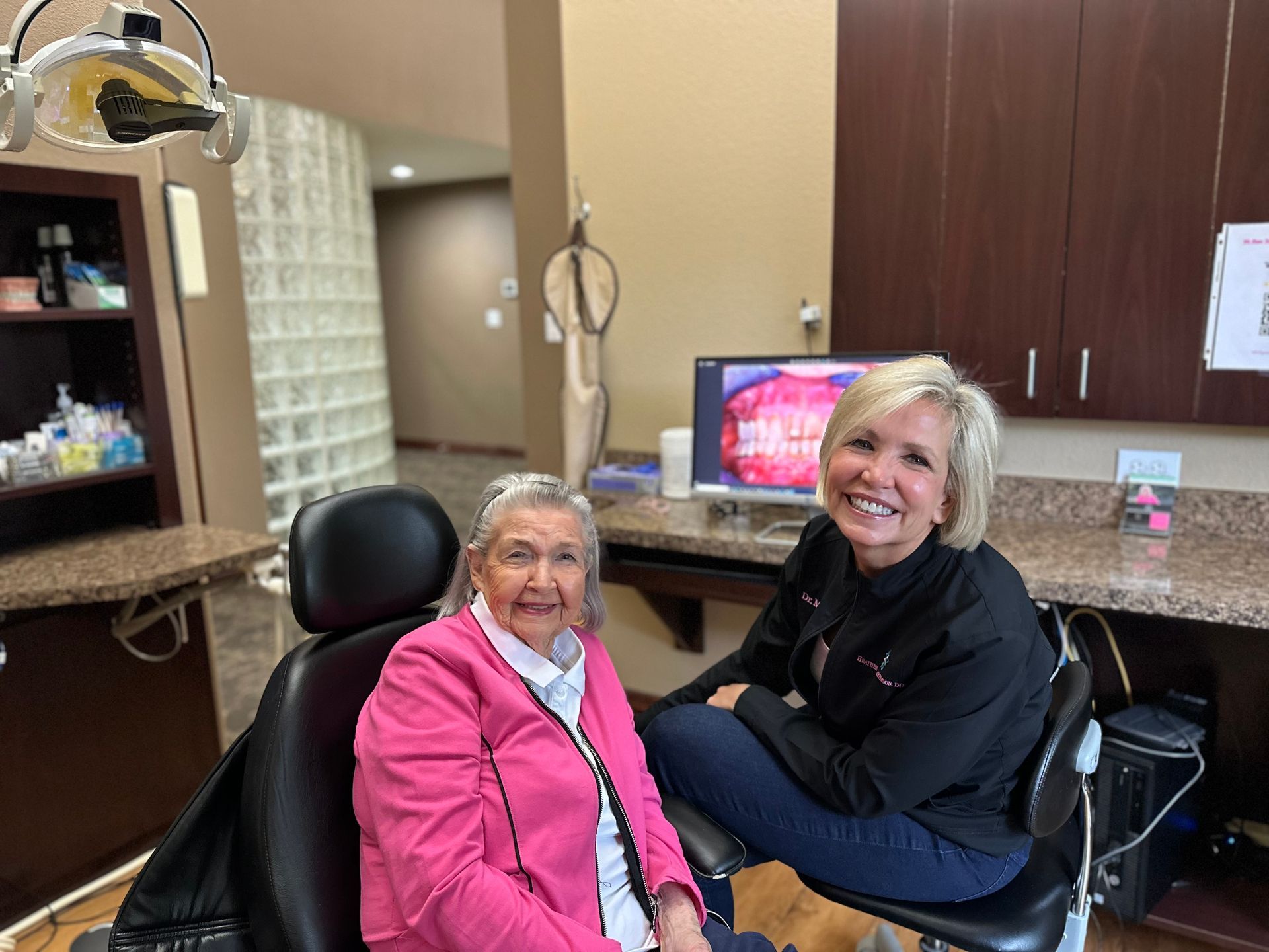 older woman smiling with dentist