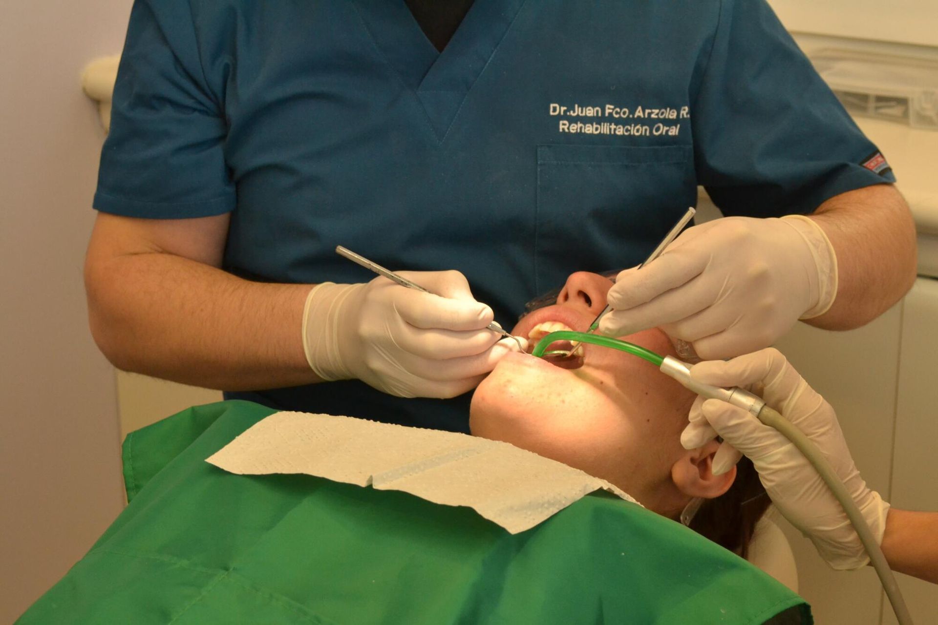 A man is getting his teeth examined by a dentist