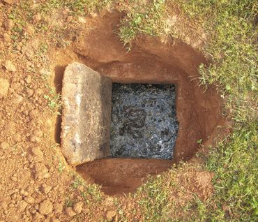 hole dug in ground to access septic tank