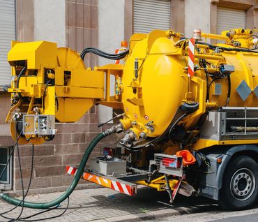 yellow septic tank pumping truck