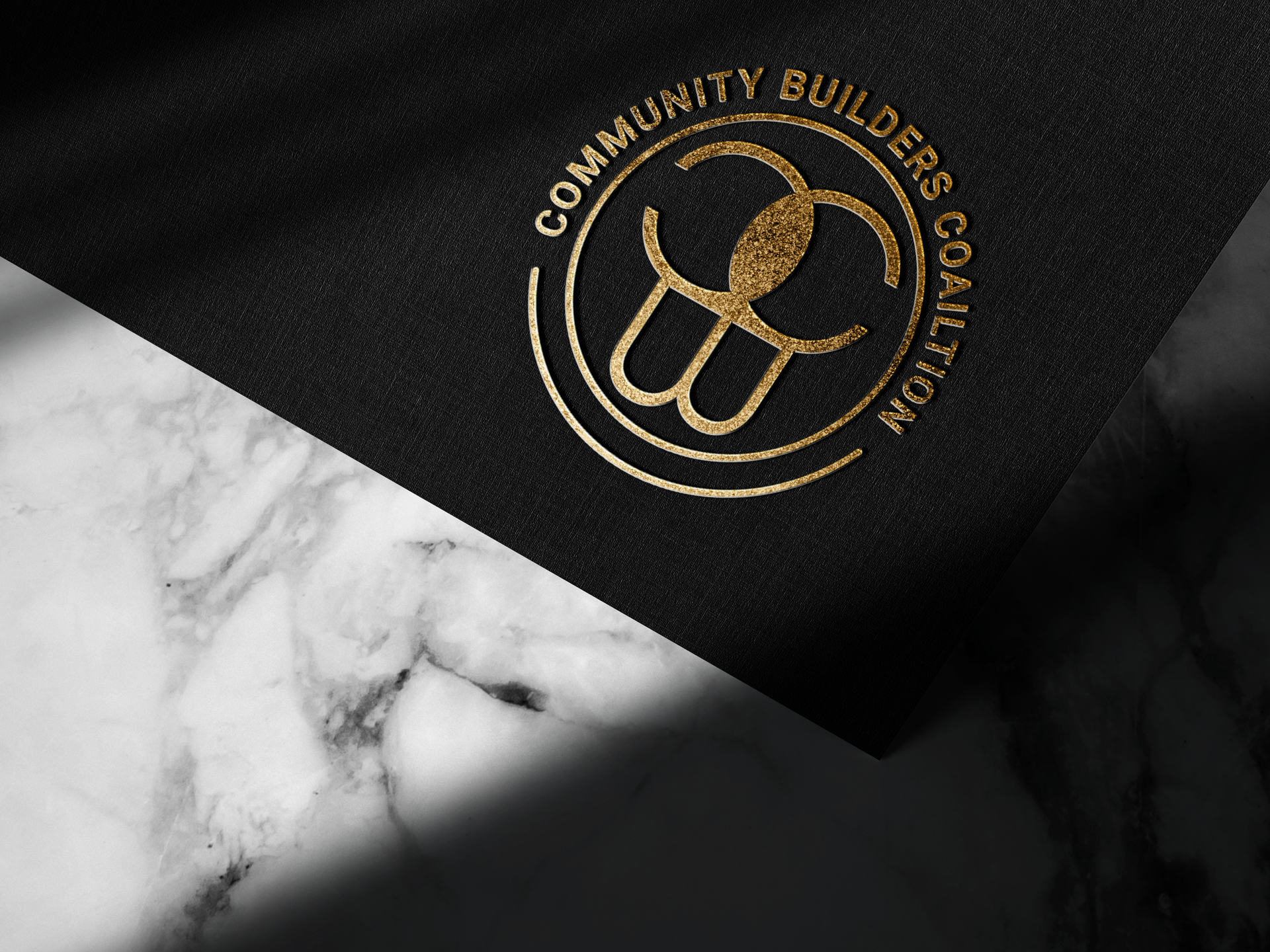 A black piece of paper that says community builders coalition