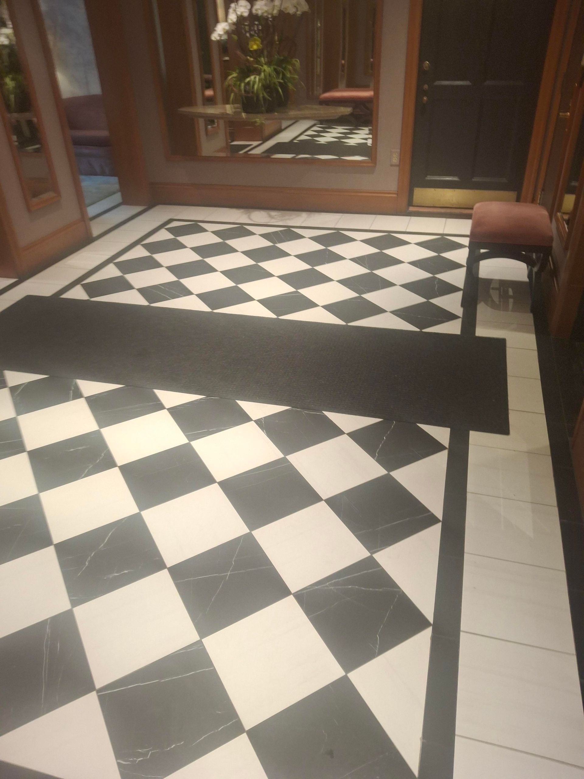 A black and white checkered floor in a hallway