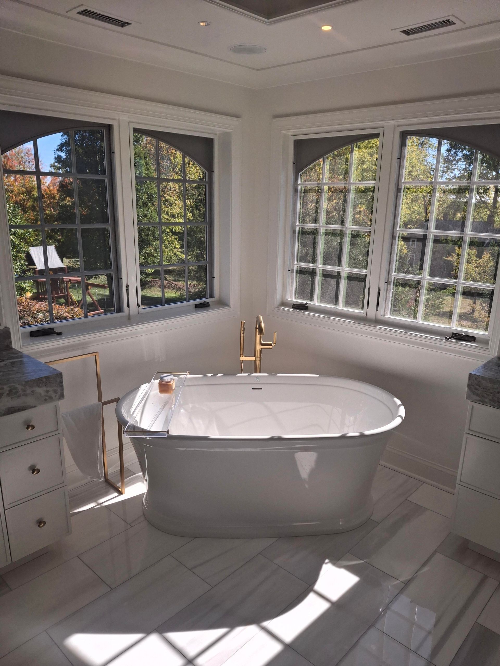 There is a bathtub in the middle of the bathroom.