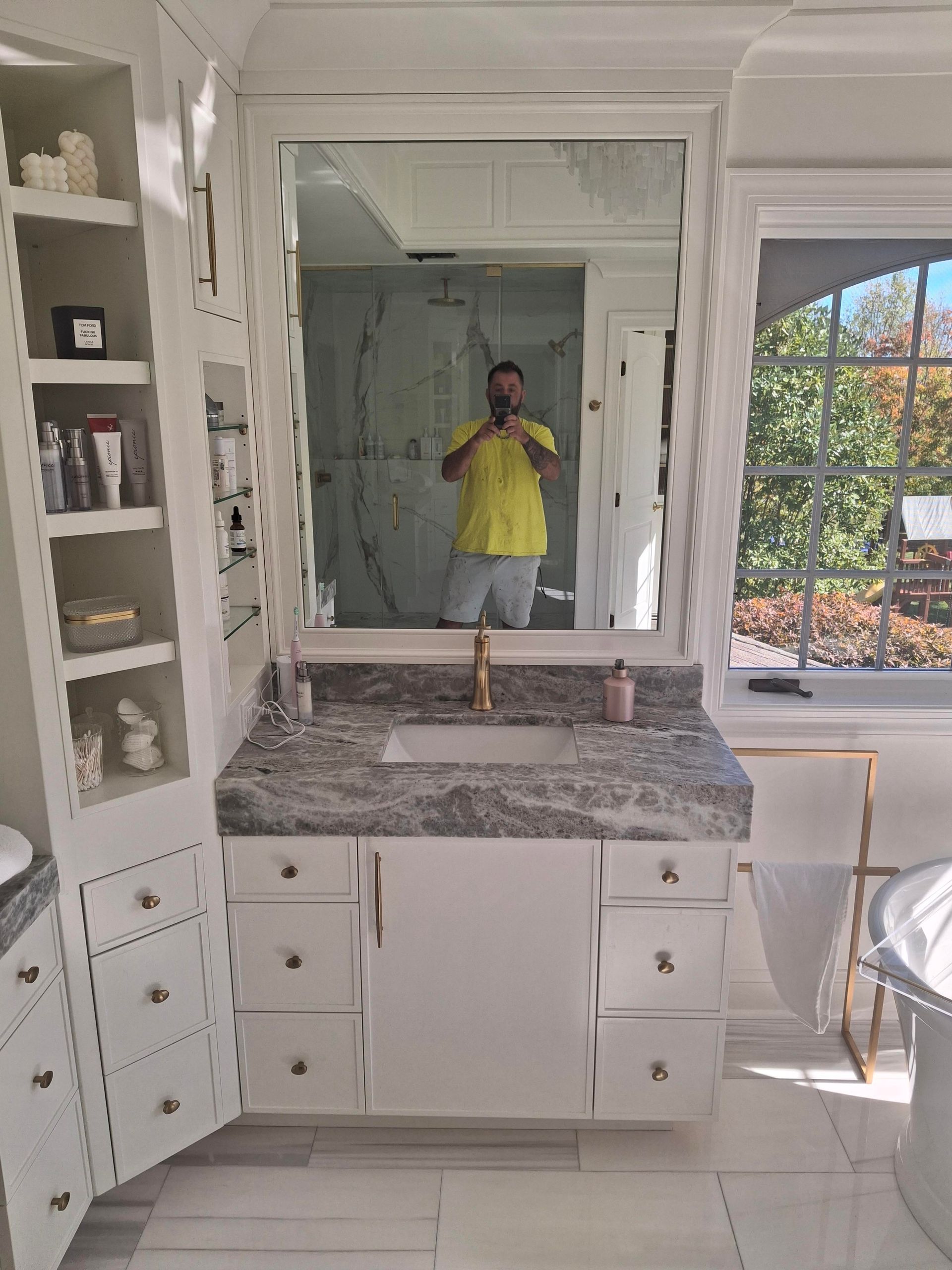 A man is taking a picture of himself in a bathroom mirror.