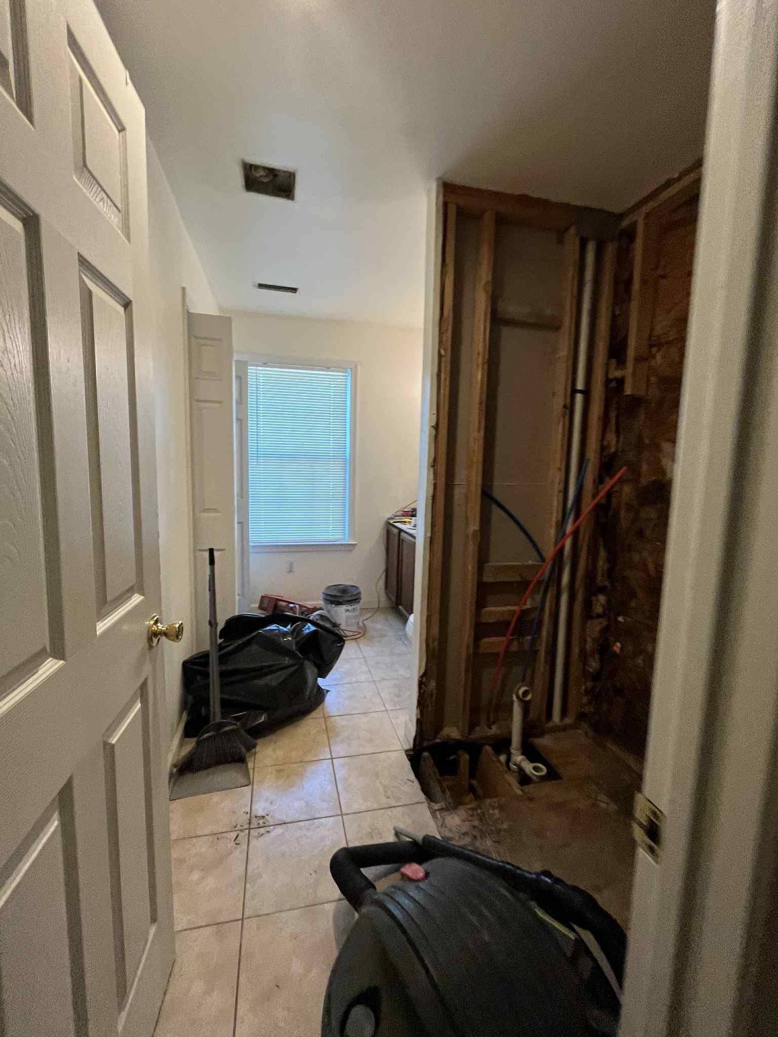 A room with a vacuum cleaner in it and a window.