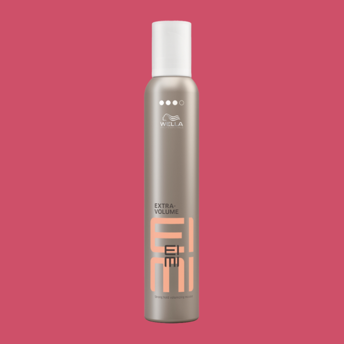 a bottle of wella extra volume mousse on a pink background