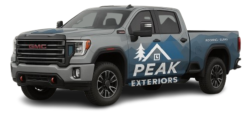 A grey GMC pickup truck branded with the blue Peak Exteriors logo featuring a mountain and pine tree graphic.