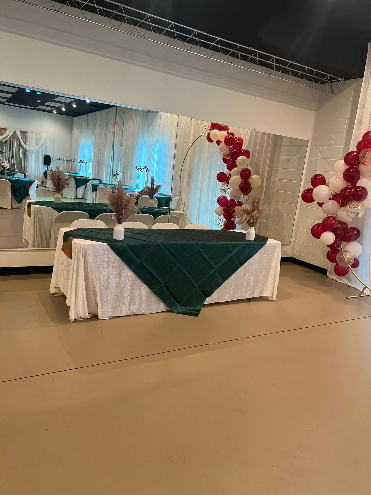 A room with tables and chairs and balloons on the wall.