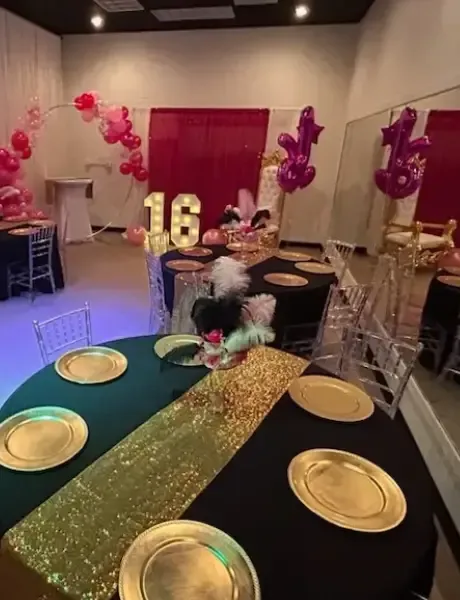 A room decorated for a birthday party with plates and balloons.
