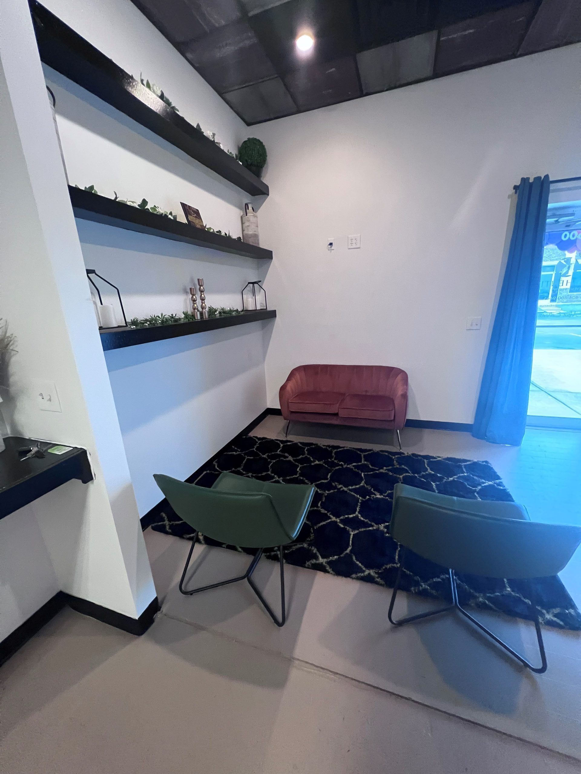 A living room with two chairs and a couch