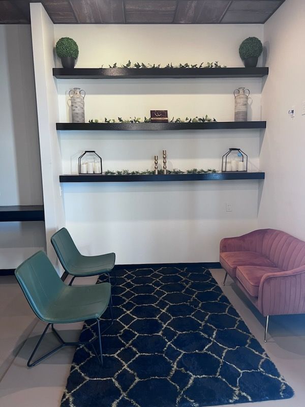 A waiting room with two chairs and a couch