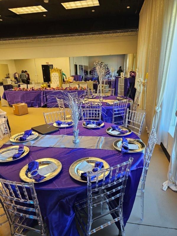 A room filled with tables and chairs set up for a party.