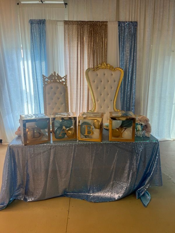 A table with a blue tablecloth and boxes on it.