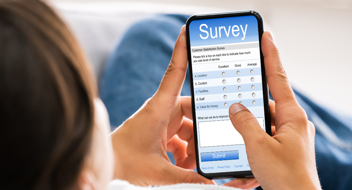 a person is holding a smart phone with a survey on it 