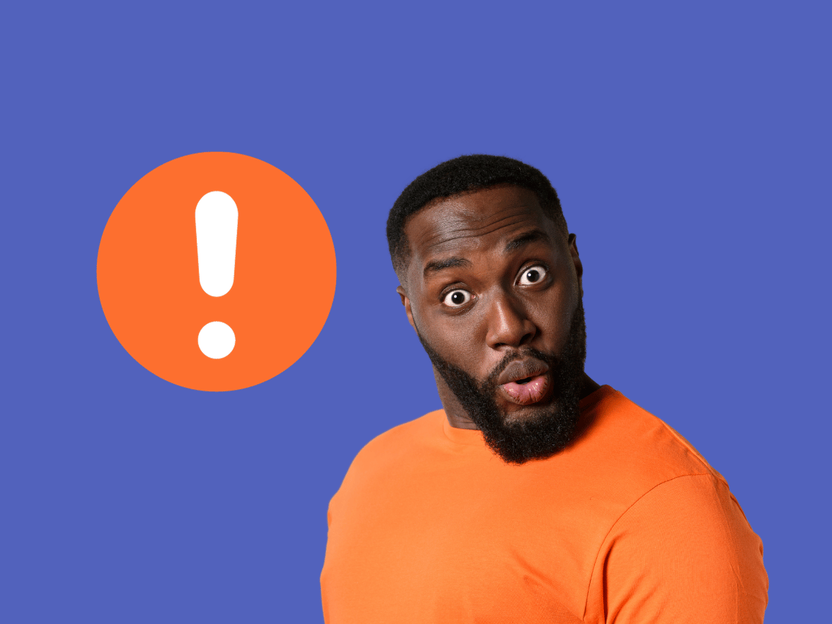 a man in an orange shirt is standing in front of an exclamation point