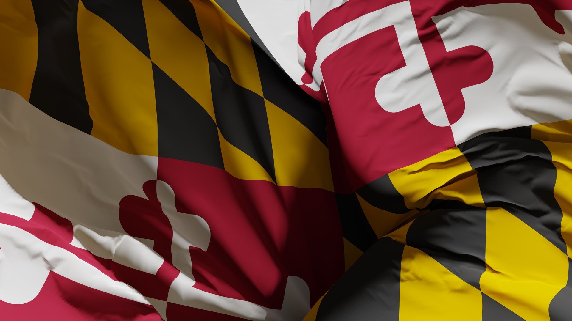 Maryland state flag, red and white cross design with yellow and black diamond design, fabric folded.