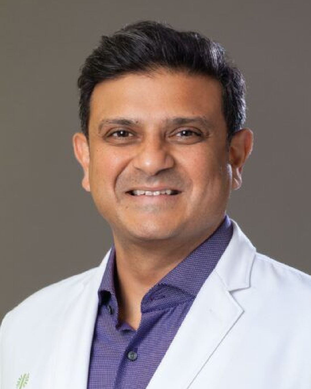 Dr. Swamy Venuturupalli in white lab coat