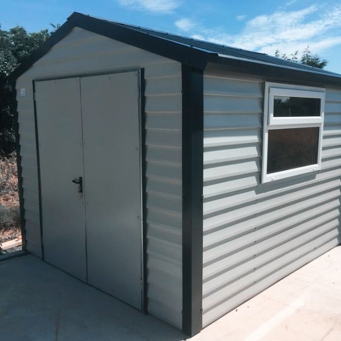 A shed with a window on the side of it