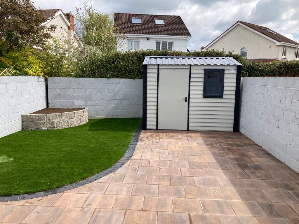 There is a shed in the backyard of a house.