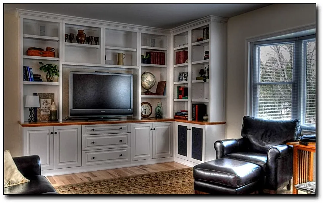 A living room with white cabinets and a flat screen tv