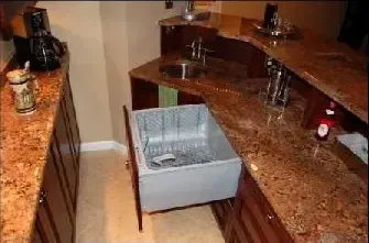 A kitchen with granite counter tops and a drawer open
