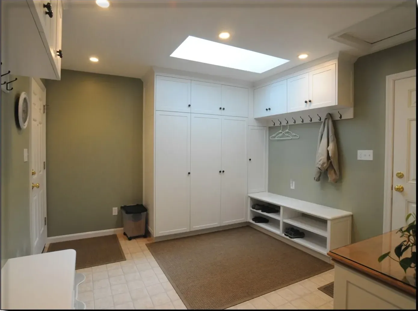 A room with white cabinets and a skylight in the ceiling
