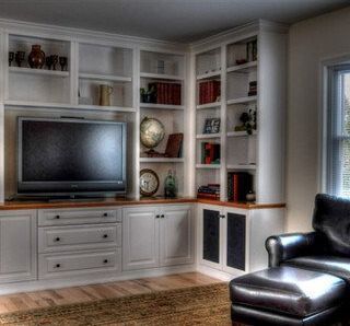 A living room with white cabinets and a flat screen tv