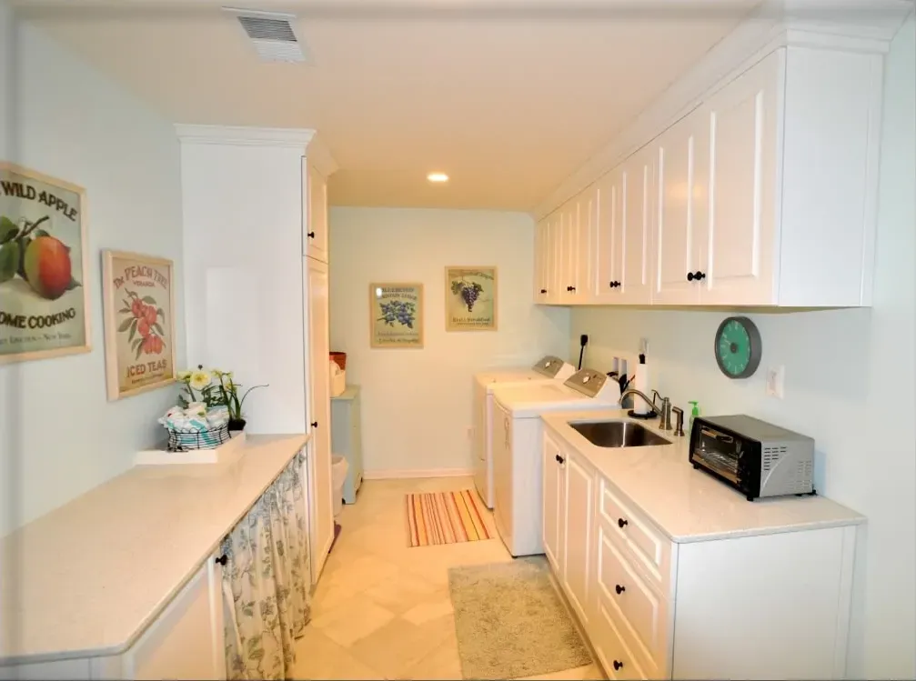 A laundry room with a sign on the wall that says 