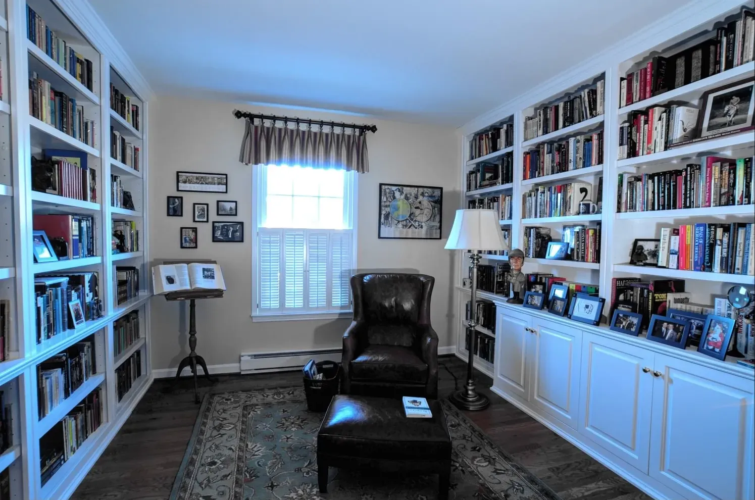 A living room filled with lots of books and pictures