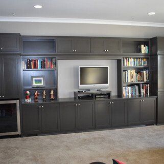 A living room with shelves and a flat screen tv