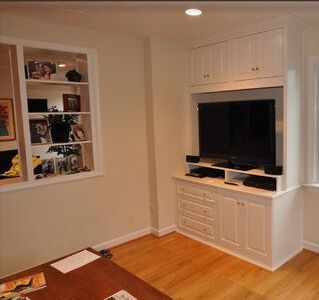 A living room with hardwood floors and a flat screen tv