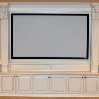 A projector screen is mounted on a wall above cabinets