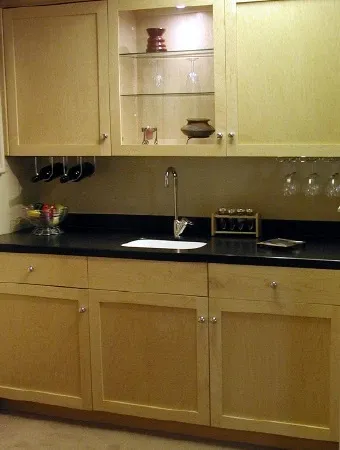 A kitchen with wooden cabinets and a sink