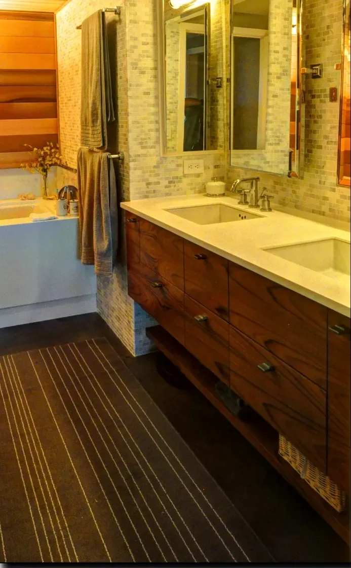 A bathroom with two sinks and two mirrors