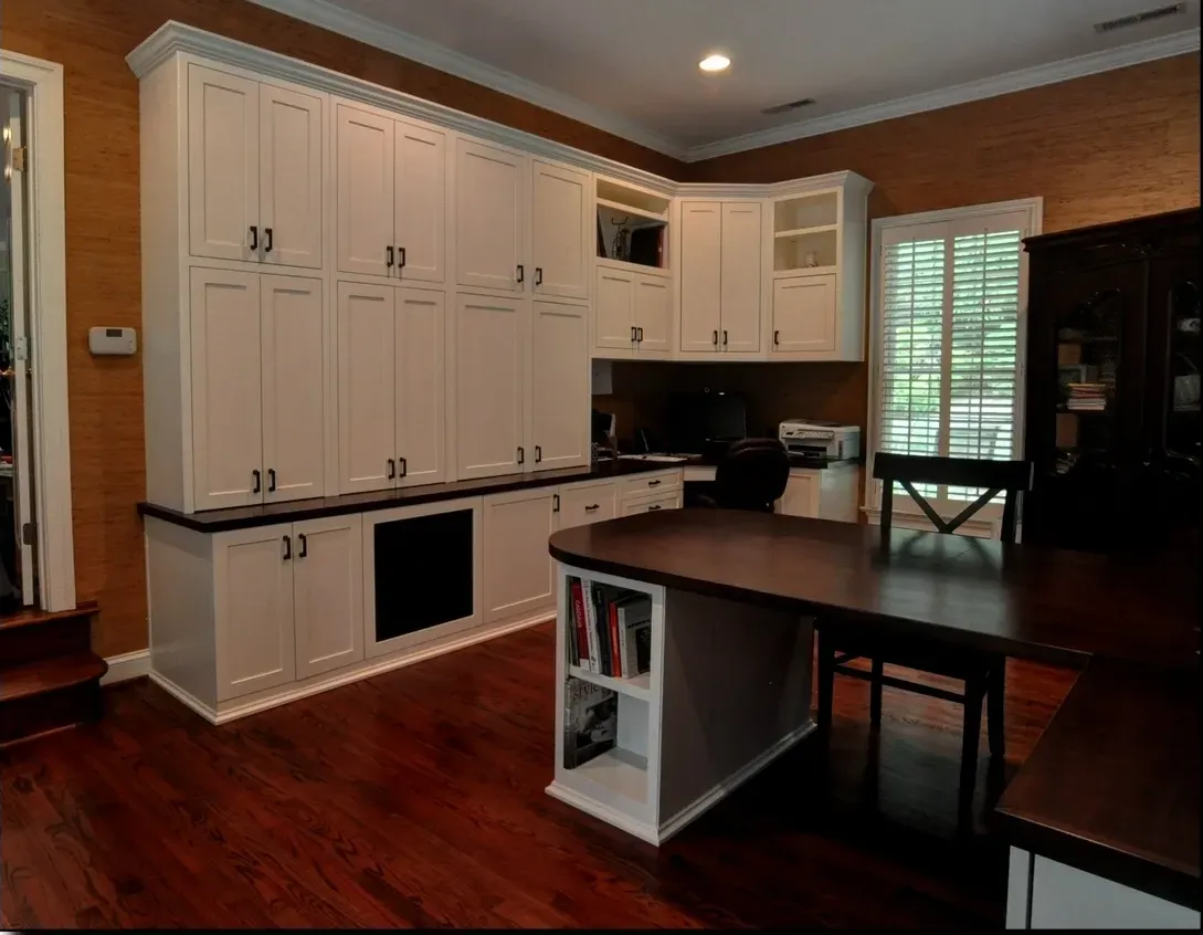 A kitchen with lots of cabinets and a table