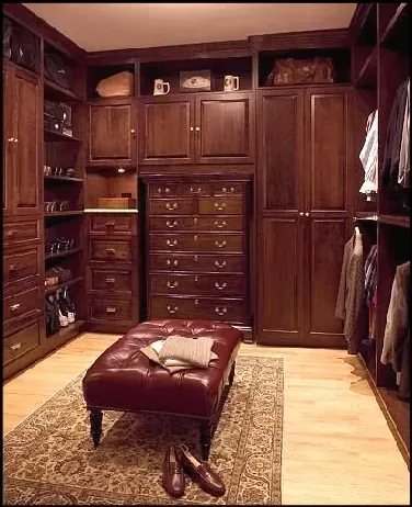 A walk in closet with lots of drawers and cabinets