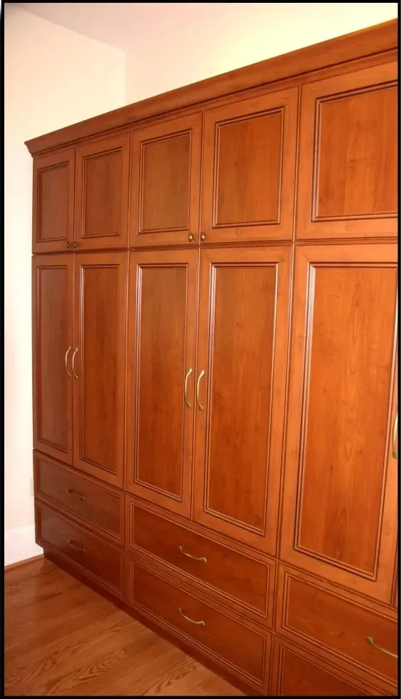 A closet with lots of wooden cabinets and drawers