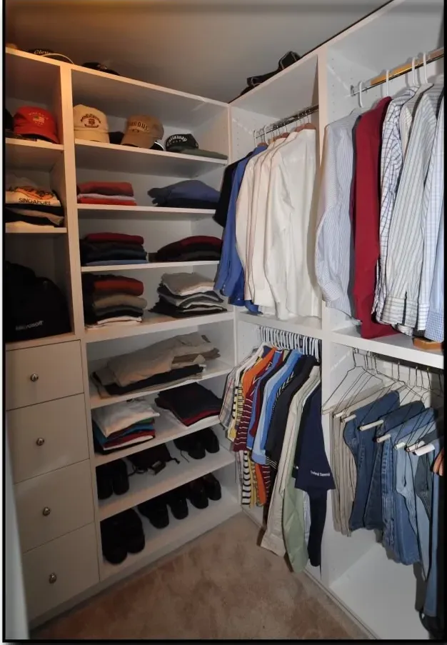 A walk in closet filled with lots of clothes and hats