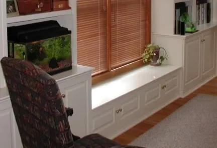 A fish tank sits on a window sill in a living room