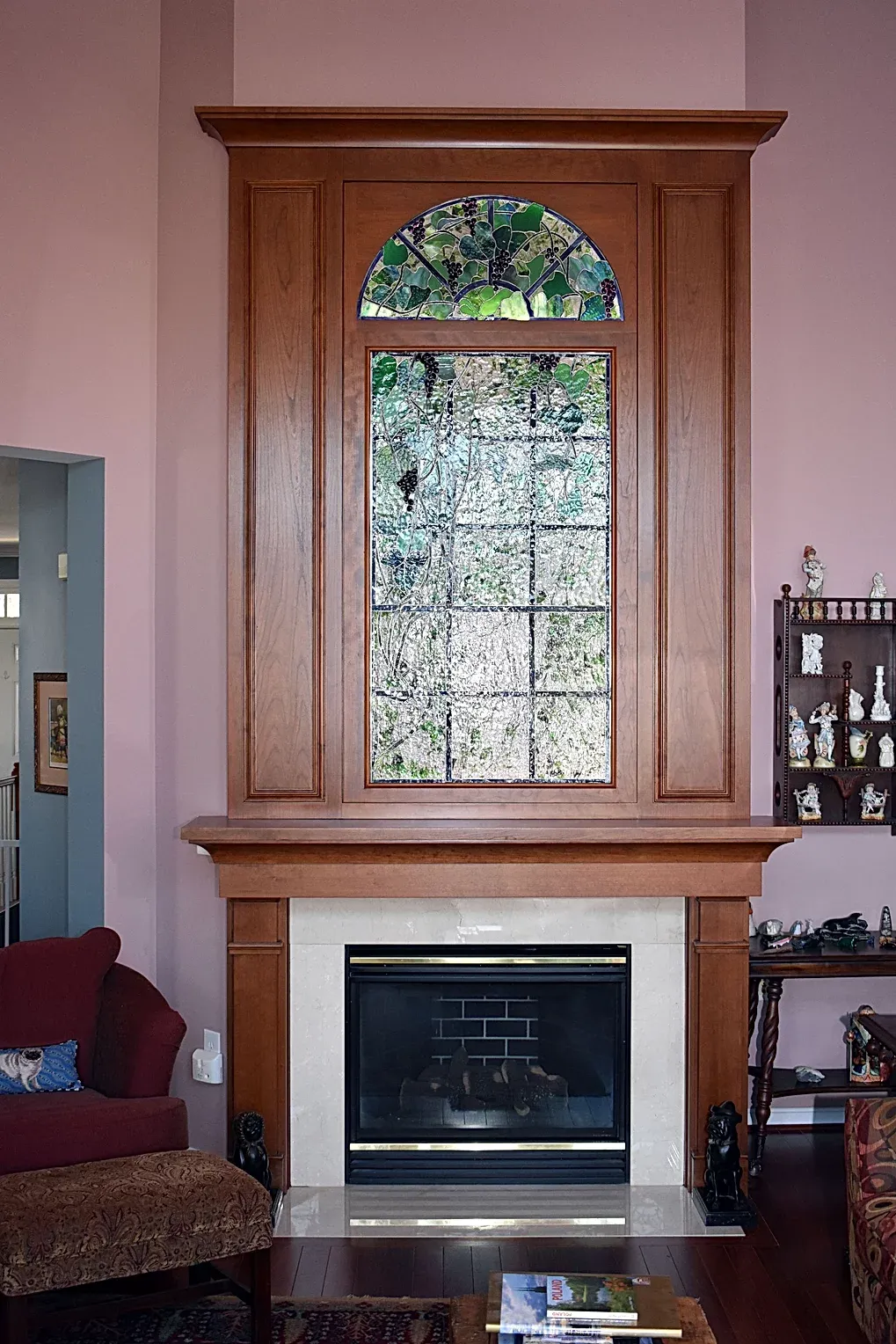 A living room with a fireplace and a stained glass window