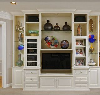 A white entertainment center with a flat screen tv